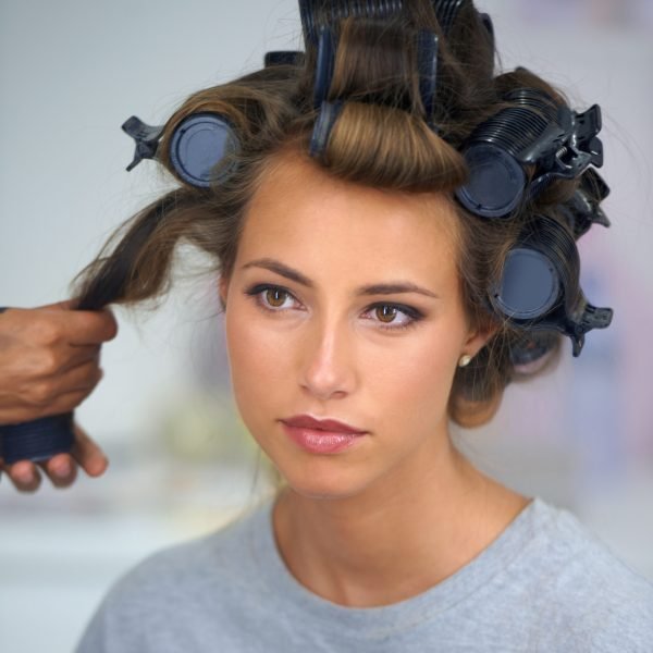 A beautiful young woman spending the day getting her hair and makeup done.